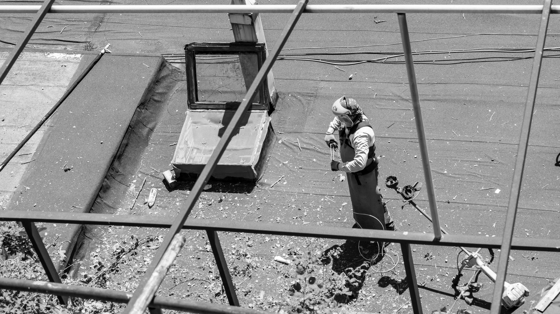 Roofing specialist working on a flat roof waterproofing layer